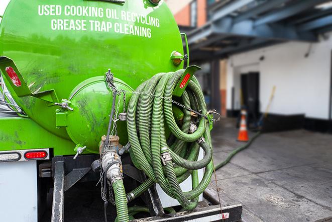 a grease trap being pumped by a sanitation technician in Ventura, CA